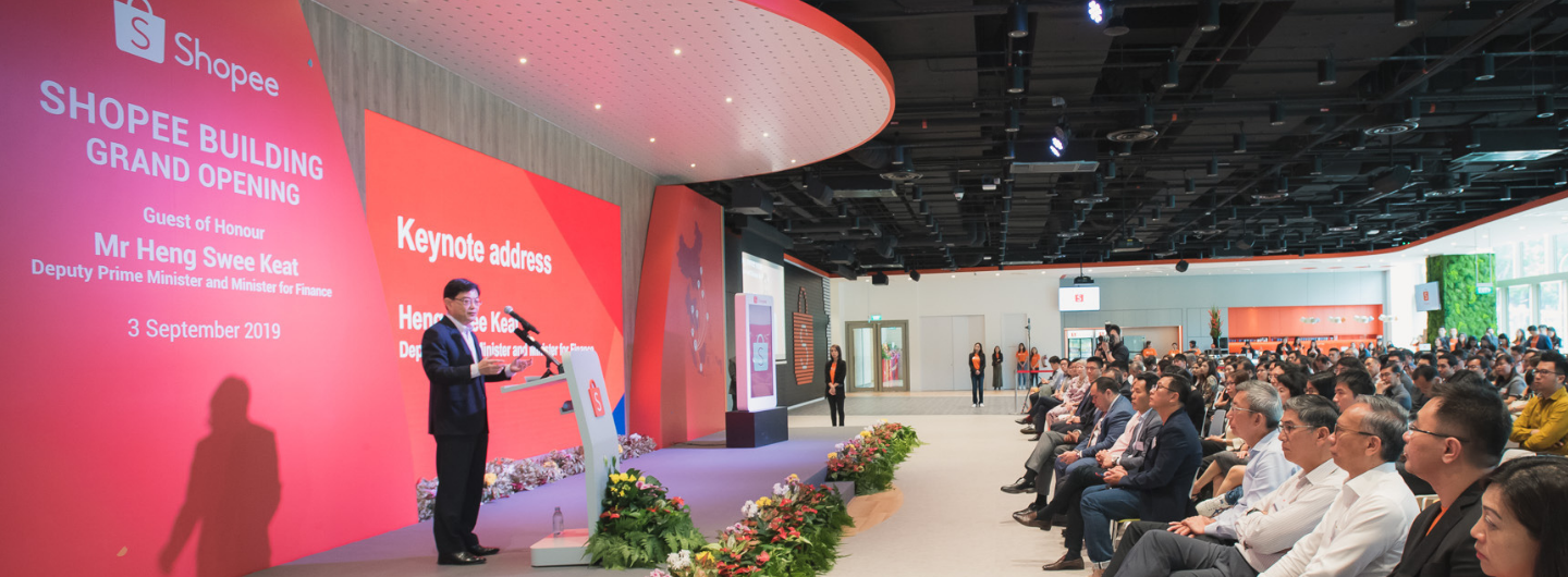 Heng Swee Keat speaks at a Shopee building grand opening to an audience.